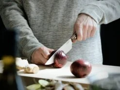 Fiskars Norr Chef's Knife -Kitchen Utensils Shop Fiskars Kitchen Action Norr Cooks knife cutting onion 1016478